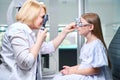 Orthoptist performing dynamic retinoscopy on little girl Royalty Free Stock Photo