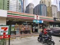 Ortigas, Metro Manila, Philippines - A 7 eleven convenience store near the CBD. Several skyscrapers in the back