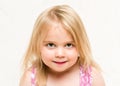 Ortrait of beautiful blonde toddler baby girl with cheeky grin