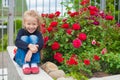 Ortrait of cute little girl near the flowers in