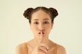 Ortrait of funny young pretty girl with two buns making funny face fooling over white background