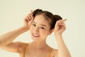 Ortrait of funny young pretty girl with two buns making funny face fooling over white background Royalty Free Stock Photo