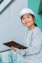 Ortrait young beautiful architect with hardhat