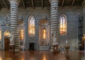 interior view of the Orvieto Cathedral central nave with pews and many statues