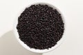 Black Rice seed. Top view of grains in a bowl. White background. Royalty Free Stock Photo