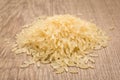 Parboiled Chinese Rice seed. Pile of grains on the wooden table. Royalty Free Stock Photo