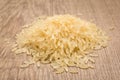 Parboiled Chinese Rice seed. Pile of grains on the wooden table.