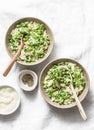 Orzo, green peas, spring herbs orzotto on a light background, top view. Vegetarian food concept