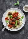 Orzo pasta with meatballs and tomato sauce on dark background, top view Royalty Free Stock Photo