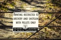 Sign of metal gate fence - Hunting Restricted to Archery and Shotgun with pellets only - posted by