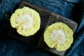 Osage Orange (Maclura pomifera) bisect on an old chopping board. Maclura use in alternative medicine