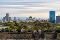 Osaka castle with cherry blossom and Osaka center business dictrick in background atOsaka, Japan. Japan spring beautiful scene. Royalty Free Stock Photo