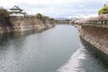 Osaka castle fortress near a canal with sakura blossom Royalty Free Stock Photo