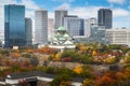 Osaka Castle with Japanese garden and city office building skyscraper at autumn season in Osaka, Japan. Japan tourism, history