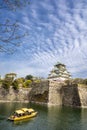 Osaka castle and a tourist boat in the city moat Royalty Free Stock Photo