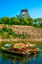 Osaka castle and traditional tour boat, a famous landmark in Osaka, Japan Royalty Free Stock Photo