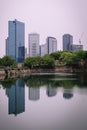 Osaka city modern downtown building with reflection in water Royalty Free Stock Photo