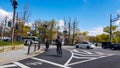 Osaka, Japan on April 10, 2019. Situation at a pedestrian crossing, where a white sporty car stops when a couple riding a bicycle Royalty Free Stock Photo