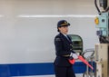 Osaka / Japan - December 20, 2017: Female Train station staff officer of Central Japan Railway Company in front of the shinkansen Royalty Free Stock Photo