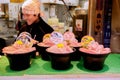 Japanese fresh and raw food tuna sashimi in black bowl for sale with young man merchant