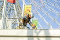 Japanese worker intend to repair and painting roof of Tempozan giant Ferris wheel entrance