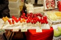 Strawberry and Cherry in wooden sticks with Japanese name and price labels.