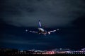 ANA Wings Boeing 737-500 landing in the night Royalty Free Stock Photo