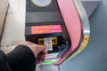 Closeup hand of people insert subway ticket in the entrance automatic ticket machines