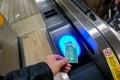 Closeup hand of people using Japan IC card `ICOCA` touch and pay at entrance automatic ticket machines