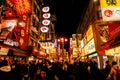 Landscape view of city night life with Japanese restaurant neon signs. Royalty Free Stock Photo