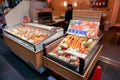 Lot of burned king crab legs and prawn in a small seafood freezer display