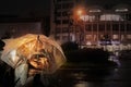 The couples will kiss under the transparent umbrella in night street while waiting for the roadside traffic signs at the entrance Royalty Free Stock Photo