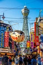 OSAKA, JAPAN - JUNE 20, 2019 :: Tsutenkaku tower located in the Shinsekai, well-known landmark of Osaka. Famous shopping streets i