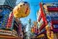 OSAKA, JAPAN - JUNE 20, 2019 :: Tsutenkaku tower located in the Shinsekai, well-known landmark of Osaka. Famous shopping streets i