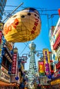 OSAKA, JAPAN - JUNE 20, 2019 :: Tsutenkaku tower located in the Shinsekai, well-known landmark of Osaka. Famous shopping streets i