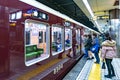 Osaka, Japan - 3 Mar 2018: Passengers walk and sit in the local underground Japan Train no. 8984 and going to the next train