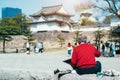 OSAKA, JAPAN, MARCH 27: An old man drawing at front of Osaka Castle. Royalty Free Stock Photo