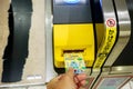 Closeup hand of people insert subway ticket in the entrance automatic ticket machines