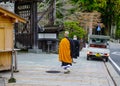 Buddhist monks walking on rural road