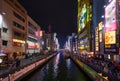 The bright night illumination over the Dotonbori canal in the Namba district in Osaka. Japan