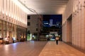 Osaka, Japan - September 25, 2015: Security officer on patrol in large office entryway at night