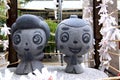 Close up picture of the small Ohatsu and Tokube stone statue at the Tsuyunoten Shrine in Osaka