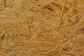 OSB board texture. Brown wooden background. Simple pressed chipboard pattern. Brown wood texture. Chip board background Royalty Free Stock Photo