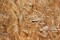 OSB board texture. Brown wooden background. Simple pressed chipboard pattern. Chip board background. Brown wood texture Royalty Free Stock Photo