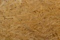 OSB board texture. Brown wooden background. Simple pressed chipboard pattern. Brown wood texture. Chip board background Royalty Free Stock Photo