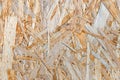 OSB boards are made of brown wood chips, sanded into a wooden background. Top view of OSB wood veneer Royalty Free Stock Photo