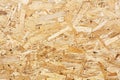 OSB boards are made of brown wood chips sanded into wooden background. Top view of OSB wood veneer background, tight Royalty Free Stock Photo