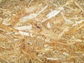 OSB boards are made of brown wood chips sanded into a wooden background. Top view of OSB wood veneer background, Royalty Free Stock Photo