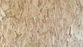 OSB boards are made of brown wood chips sanded into a wooden background Royalty Free Stock Photo