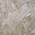 OSB boards are made of sawdust polished on a wooden background. Recycled compressed wood chipboard Royalty Free Stock Photo